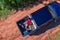 Aerial view of a woman sitting in the back of a pickup truck with her dogs and suitcase