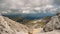 Aerial view of wonderful mountain valley under large moving clouds in summer. Stunning nature of Caucasian snowy