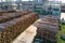 Aerial view of wood processing factory with stacks of lumber at plant manufacturing yard