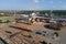 Aerial view of wood processing factory with stacks of lumber at plant manufacturing yard