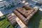 Aerial view of wood processing factory with stacks of lumber at plant manufacturing yard