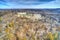 Aerial View of Woods in Fall Colors with a Farmhouse