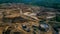 Aerial view of Work of trucks and the excavator in an open pit on gold mining. Central Sulawesi, Indonesia, March 3, 2022