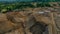 Aerial view of Work of trucks and the excavator in an open pit on gold mining. Central Sulawesi, Indonesia, March 3, 2022