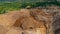 Aerial view of Work of trucks and the excavator in an open pit on gold mining. Central Sulawesi, Indonesia, March 3, 2022