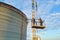 Aerial view of workers on cement factory under construction with high concrete plant structure and tower cranes at industrial