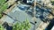 Aerial view of workers at new house construction site pouring concrete of flat slab foundation bedding ready for