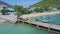 Aerial view workers transport sacks along pier to lorry