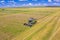 Aerial view of working combine in cereal field