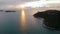 Aerial view of a yacht with beautiful sunset. Amazing light sunset or sunrise. Sailing boat standing on the small waves