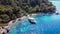 Aerial view of yacht in blue sea anchored near island with sand coast and turquoise water. Touristic excursion boat ship