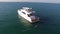 Aerial view of yacht or boat with people cruising at open sea. Stock. Aerial view of a yacht in a crystal clear sea