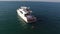 Aerial view of yacht or boat with people cruising at open sea. Stock. Aerial view of a yacht in a crystal clear sea
