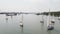 Aerial view on Yachts on an anchor in harbor, boats series. Sail Boats on a beautiful cloudless day in the marina