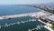 Aerial view of yachts and boats moored at marina and panorama of seaside city