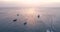 Aerial view of yachts and fishing boats in blue sea at sunset in summer