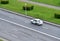 Aerial view on Yandex Taxi passenger car rides on the wet road.