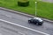 Aerial view on Yandex Taxi passenger car rides on the wet road. Small roughness sharpness, possible