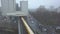 AERIAL: View on Yellow Subway Train going over Bridge into Train Station in Berlin, Cloudy, Foggy