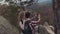 Aerial view of a young adorable people taking selfie on the top of the mountain, smiling, and laughing. Gorgeous scenery