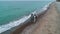 Aerial view of young couple walk on beach