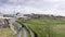 Aerial view of Young couple walking trough a village path hand in hand. Adventured holiday in Ireland, green field