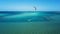 Aerial view young man kite surfing in tropical blue ocean