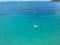 Aerial view young woman on giant inflated flamingo float in turquois water of Ionian Sea Albania