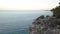 Aerial View of Young Woman on Rock Cliff Against Sea