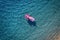 Aerial view of young woman swimming on the pink inflatable mattr