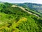 Aerial views of green fields and hills surronding San-Marino microstate. Travelling across the beautiful Emilia-Romagna region of