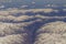 Aerial views in mountain. View from the plane window. The Hindu Kush mountain system in Afghanistan