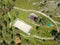 Aerial vire on two sports fields for football and basketball in the Altai mountains among green trees in the fresh air. Sports and