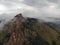 Aerial viw of fog among the mountain peaks. Bad weather and fog in the Siberian nature reserve Stolby.