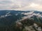 Aerial viw of fog among the mountain peaks. Bad weather and fog in the Siberian nature reserve Stolby.