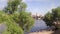 Aerial of Vltava river and iconic Charles bridge, birds flying in front of camera