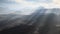 Aerial volcanic desert landscape with rays of light