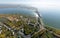 Aerial water power plant view with crossroads and roads, civil buildings.