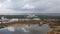 Aerial wide view of cityscape with coastline on a cloudy day. Drone shot of urban background.