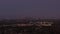 Aerial: wide view of downtown Los Angeles, California Skyline from Culver City at Dusk, Night with Purple Sky