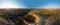 Aerial wide view of Love Valley Peri Bacalari Sunset over Red valley in Cappadocia canyon, mountains and balloons.. Nevsehir