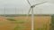 Aerial: wind mill rotating by the force of the wind and generating renewable energy in a green ecologic way for the