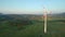 Aerial - Wind turbine blocking the sun with propeller at sunset