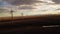 Aerial Wind Turbine Cinematic View of Windmills producing renewable energy on Alberta Farmlands