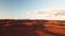 Aerial, wind turbines on remote red hills in Australian outback desert