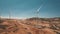 Aerial wind turbines rotate in desert against blue sky. Panorama summer desert and brown rock land.