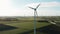 Aerial windmills wind turbines producing clean ecological electricity in green agricultural fields on sunny day. Wind