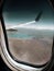 Aerial wing airplane. Views through the window of an airplane of the Patagonia in Argentina, lake. Cloudy light blue sky. Concept