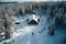 Aerial winter cabin scene in Sweden, featuring a lone man