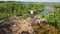 Aerial: woman climbs on top of the mountain